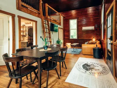a dining room with a table and chairs at Corton Lodge on the Elk River - Riverview Suite