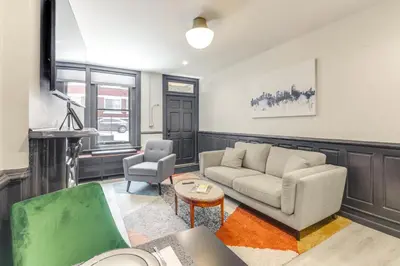 a living room with a couch and a chair at Cincy Apt 1 Mi to Findlay Market, 2 Mi to Downtown in Cincinnati