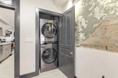 a kitchen with two washing machines in a door at Cincy Apt 1 Mi to Findlay Market, 2 Mi to Downtown in Cincinnati