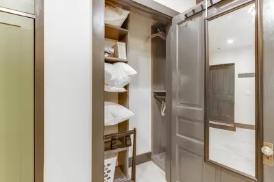 a walk in closet with a mirror and shelves at Cincy Apt 1 Mi to Findlay Market, 2 Mi to Downtown in Cincinnati