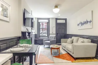 a living room with a couch and a table at Cincy Apt 1 Mi to Findlay Market, 2 Mi to Downtown in Cincinnati