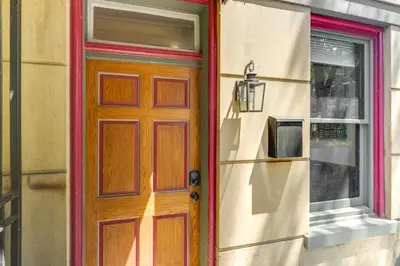 a wooden door on a building with a window at Cincy Apt 1 Mi to Findlay Market, 2 Mi to Downtown in Cincinnati