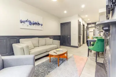 a living room with a couch and a table at Cincy Apt 1 Mi to Findlay Market, 2 Mi to Downtown in Cincinnati