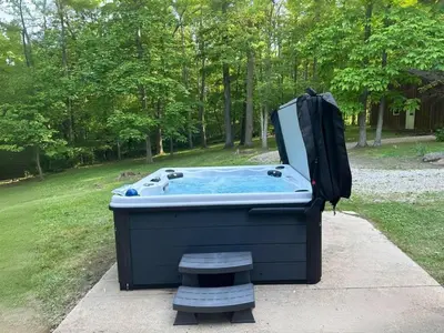 a hot tub with a backpack on top of it at Havenbrook-Hocking Hills Luxury, 10 Acres, Hot Tub in New Plymouth