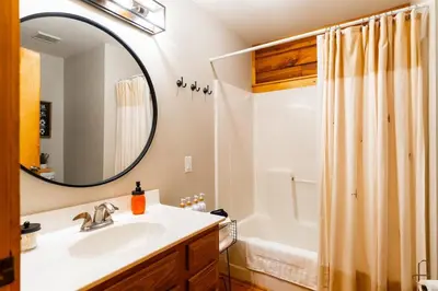 a bathroom with a sink and a mirror at Havenbrook-Hocking Hills Luxury, 10 Acres, Hot Tub in New Plymouth