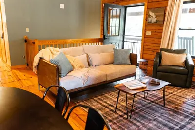 a living room with a couch and a table at Havenbrook-Hocking Hills Luxury, 10 Acres, Hot Tub in New Plymouth
