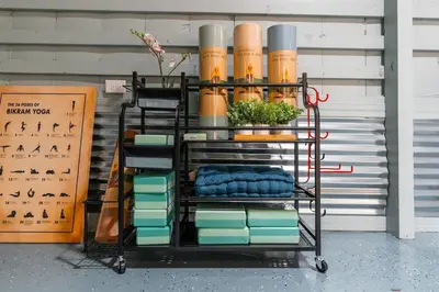 a rolling cart with books and a plant on it at Havenbrook-Hocking Hills Luxury, 10 Acres, Hot Tub in New Plymouth