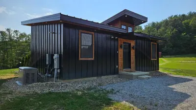 a small black building with at The Mysa - Couples Retreat, Luxe, Sauna, Hot tub in Rockbridge