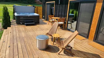 a deck with a grill and two chairs and a table at The Mysa - Couples Retreat, Luxe, Sauna, Hot tub in Rockbridge