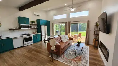 a living room with a couch and a kitchen at The Mysa - Couples Retreat, Luxe, Sauna, Hot tub in Rockbridge