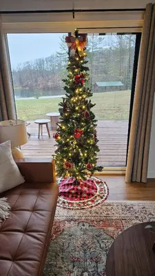 a christmas tree in a living room with a couch at The Mysa - Couples Retreat, Luxe, Sauna, Hot tub in Rockbridge
