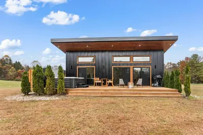 a modern house with a large deck and windows at The Mysa - Couples Retreat, Luxe, Sauna, Hot tub in Rockbridge