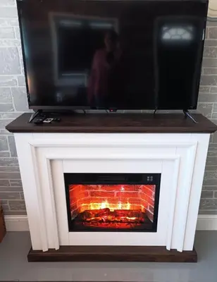a fireplace with a television on top of it at The Reel Freedom Cottage at Leesville Lake in Carrollton