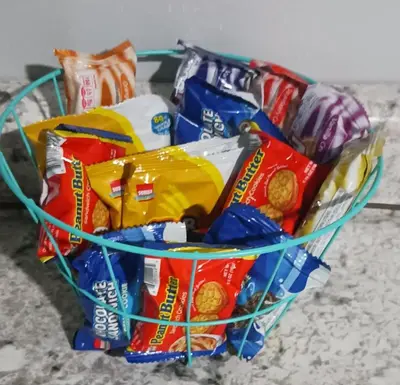 a basket filled with chips and other snacks at The Reel Freedom Cottage at Leesville Lake in Carrollton