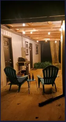 two chairs and a table in a yard at night at The Reel Freedom Cottage at Leesville Lake in Carrollton