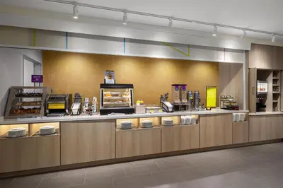 a fast food restaurant with a counter with food at Home2 Suites By Hilton Muncie in Muncie