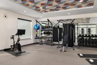 a fitness room with a gym with tread machines at Home2 Suites By Hilton Muncie in Muncie