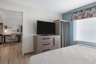 a bedroom with a bed and a television on a dresser at Home2 Suites By Hilton Muncie in Muncie
