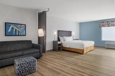 a hotel room with a bed and a couch at Home2 Suites By Hilton Muncie in Muncie