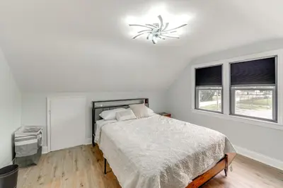 a white bedroom with a bed and two windows at 3 Mi to Dtwn Youngstown and YSU Family Home with Yard in Youngstown