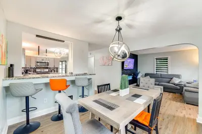 a kitchen and living room with a table and chairs at 3 Mi to Dtwn Youngstown and YSU Family Home with Yard in Youngstown