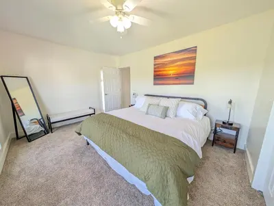 a bedroom with a bed and a ceiling fan at Cozy Upstairs Unit Near River and Marina Access in Fremont