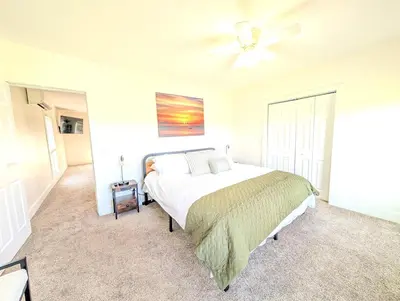 a bedroom with a bed and a ceiling fan at Cozy Upstairs Unit Near River and Marina Access in Fremont