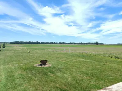 a field with a bucket in the middle of it at Cozy Upstairs Unit Near River and Marina Access in Fremont