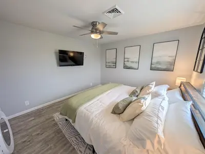 a bedroom with a bed and a ceiling fan at Relaxing River View Stay Renovated 3BR Home in Fremont