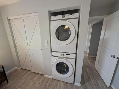 a washer and dryer in a room with a door at Relaxing River View Stay Renovated 3BR Home in Fremont