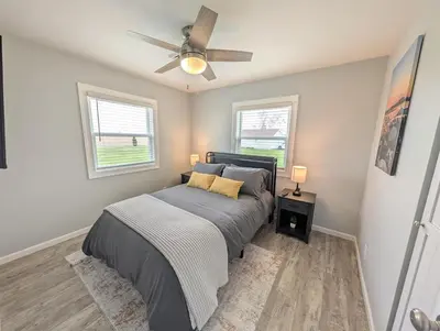 a bedroom with a bed and a ceiling fan at Relaxing River View Stay Renovated 3BR Home in Fremont