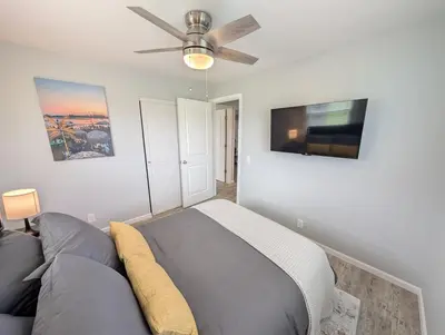 a bedroom with a bed and a ceiling fan at Relaxing River View Stay Renovated 3BR Home in Fremont
