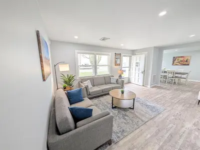 a living room with a couch and a table at Relaxing River View Stay Renovated 3BR Home in Fremont