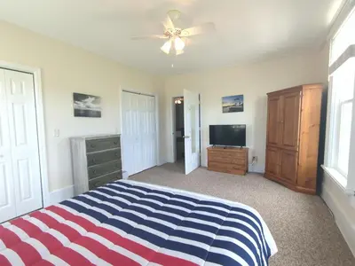 a bedroom with a bed and a ceiling fan at Country Charm on the Sandusky Live Music Nearby in Fremont