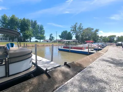 a boat is docked at a marina with other boats at Country Charm on the Sandusky Live Music Nearby in Fremont