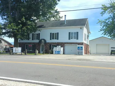a white house on the side of a street at Country Charm on the Sandusky Live Music Nearby in Fremont