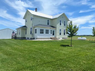 a large white house on a grass field at Country Charm on the Sandusky Live Music Nearby in Fremont