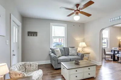 a living room with a couch and a ceiling fan at 1 Mi to Water and Dtwn Lake Erie Family Getaway in Sandusky