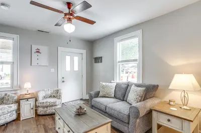 a living room with a couch and a ceiling fan at 1 Mi to Water and Dtwn Lake Erie Family Getaway in Sandusky