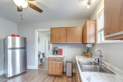 a kitchen with wooden cabinets and a stainless steel refrigerator at 1 Mi to Water and Dtwn Lake Erie Family Getaway in Sandusky
