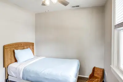 a small bedroom with a bed and a window at 1 Mi to Water and Dtwn Lake Erie Family Getaway in Sandusky