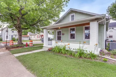 a green house with a tree and a yard at 1 Mi to Water and Dtwn Lake Erie Family Getaway in Sandusky