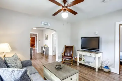 a living room with a couch and a flat screen tv at 1 Mi to Water and Dtwn Lake Erie Family Getaway in Sandusky