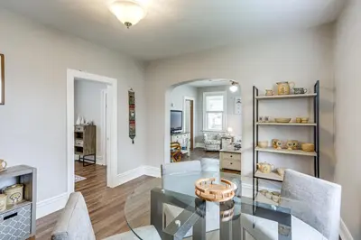 a living room with a glass table and chairs at 1 Mi to Water and Dtwn Lake Erie Family Getaway in Sandusky