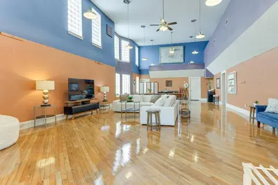 a large living room with blue walls and wooden floors at Downtown Apt 23 Mi to Hocking Hills State Park in Lancaster