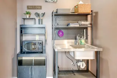 a kitchen with a sink and a microwave at Downtown Apt 23 Mi to Hocking Hills State Park in Lancaster