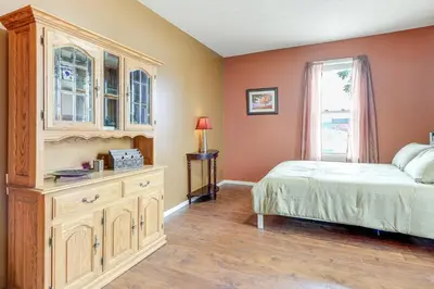 a bedroom with a bed and a dresser and a window at Downtown Apt 23 Mi to Hocking Hills State Park in Lancaster