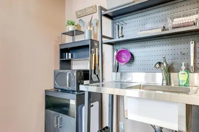 a kitchen with a sink and a microwave at Downtown Apt 23 Mi to Hocking Hills State Park in Lancaster