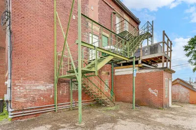 a staircase on the side of a brick building at Downtown Apt 23 Mi to Hocking Hills State Park in Lancaster