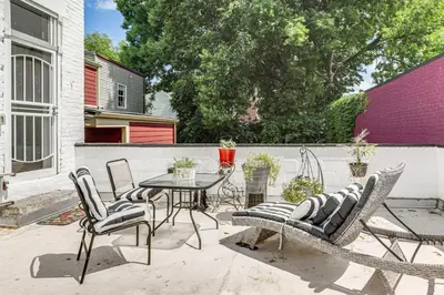 a patio with a table and chairs and a fence at Walkable Apt in York St Historic District in Newport